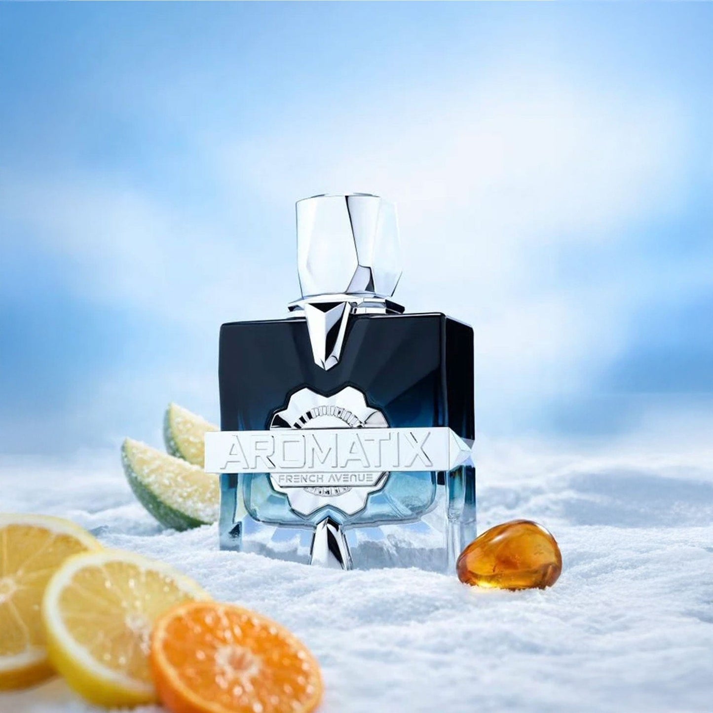 Perfume bottle with 'Aromatix' branding on a snowy background with fruits.