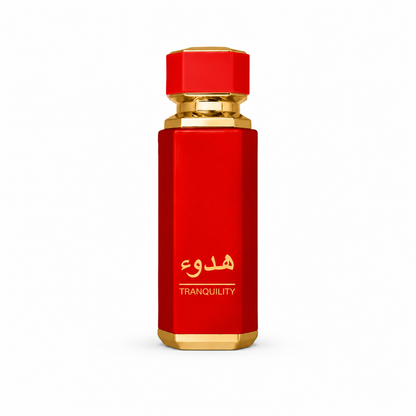 A red cylindrical perfume bottle with gold accents, featuring gold Arabic calligraphy and the word 'TRANQUILITY' on the front, set against a plain white background.