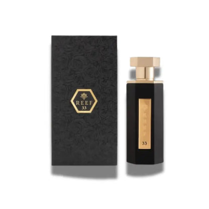Black perfume bottle with gold accents and matching box featuring 'REEF' branding on a white background
